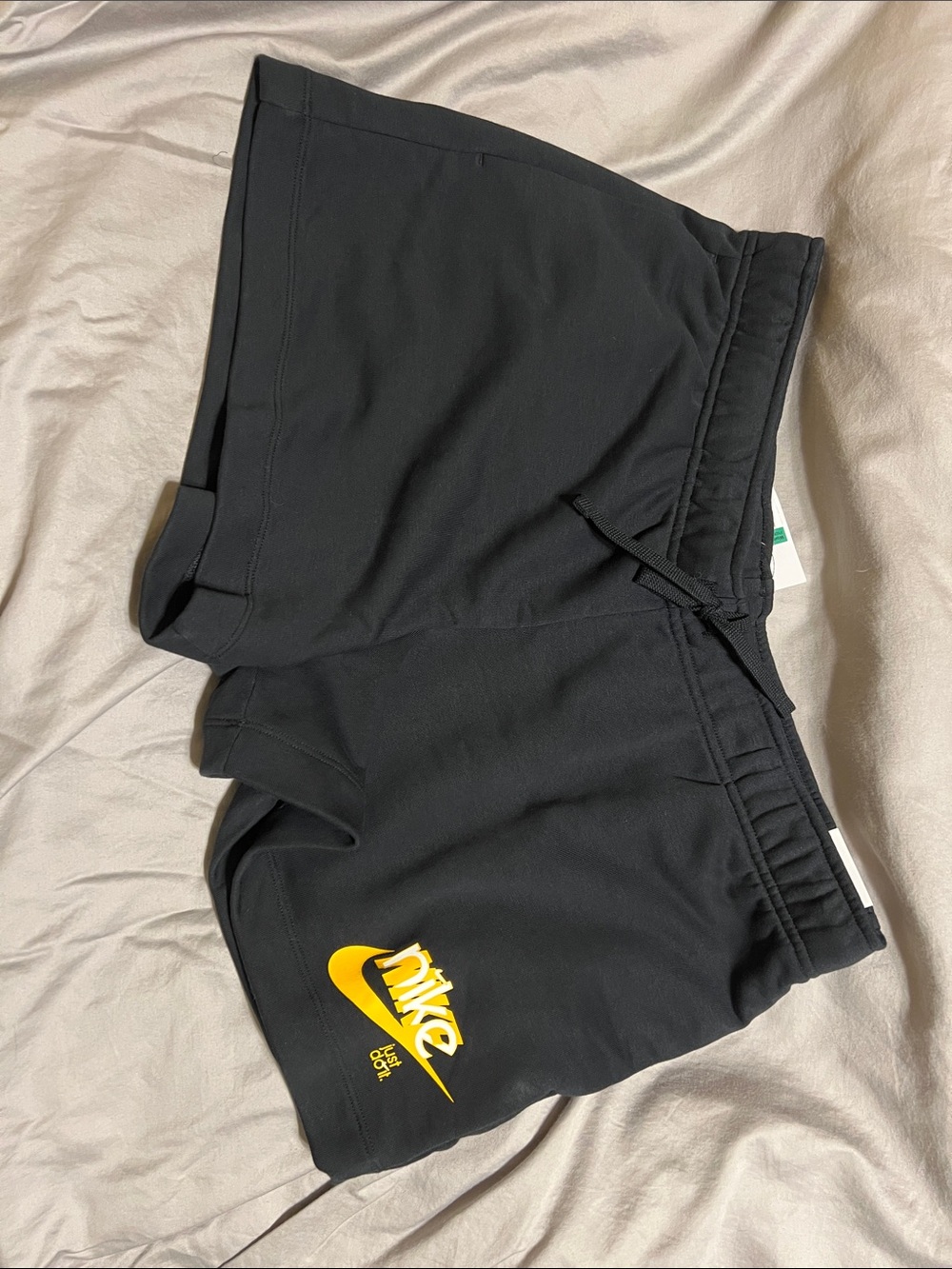 Nike Black Athletic Shorts with Yellow Swoosh Logo
